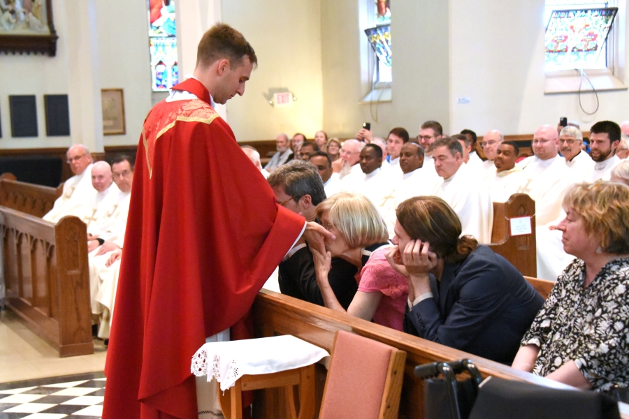 Father Valles' parents kiss his hands.