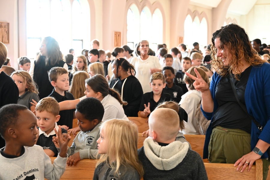 students giving each other the sign of peace