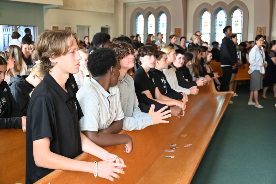 Students praying during Mass