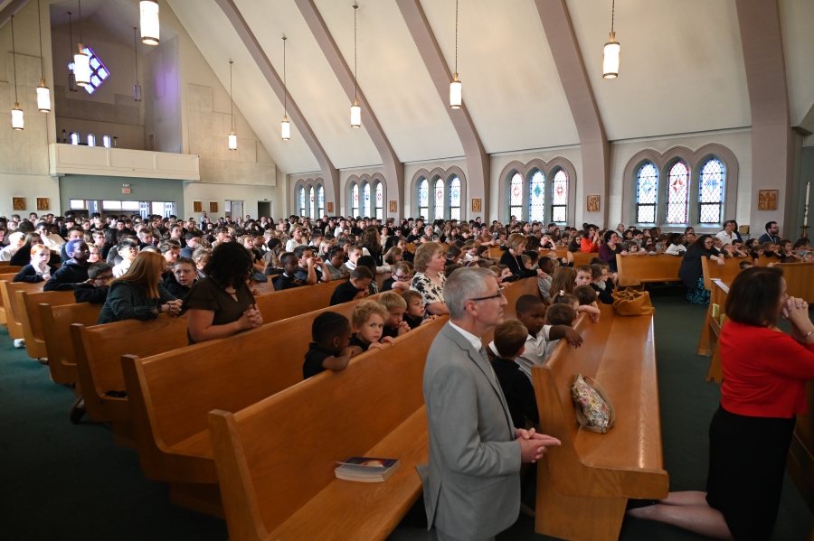 students, teachers, staff at Mass in church 