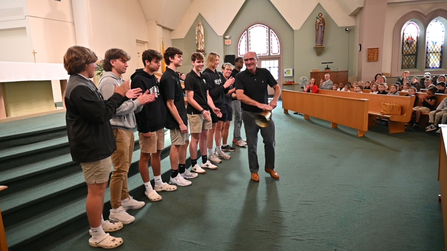 Saint Dominic Academy's State Championship baseball team ringing a victory bell 