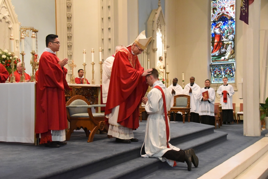 Bishop James Ruggieri lays hands on Deacon Matthew Valles.
