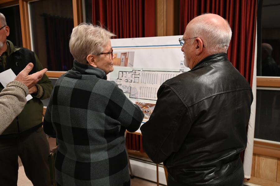 Couple reading information on a poster