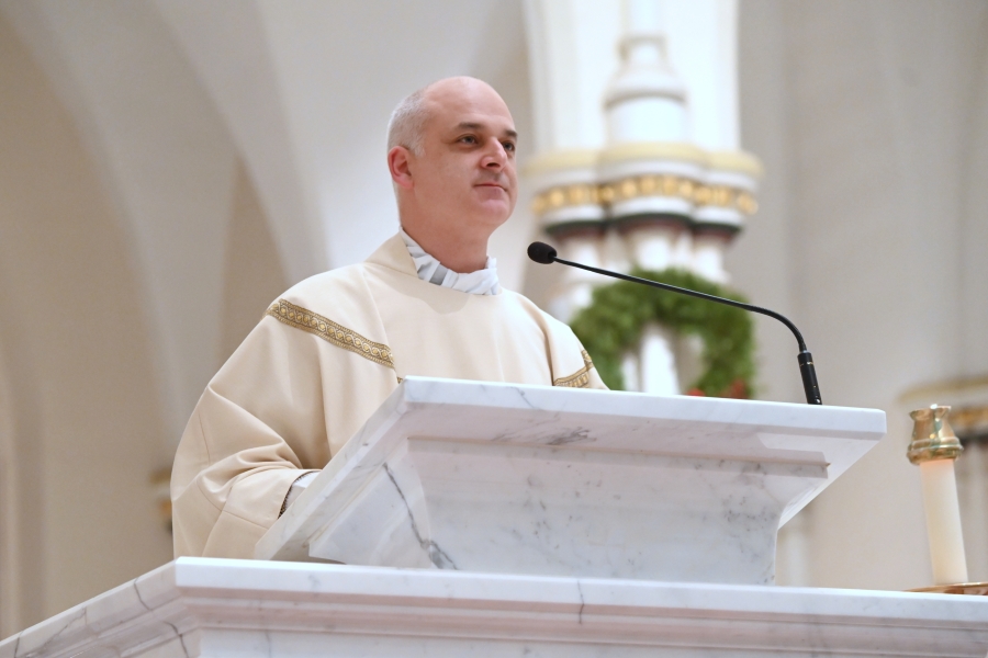 Father Seamus Griesbach reads the Gospel.