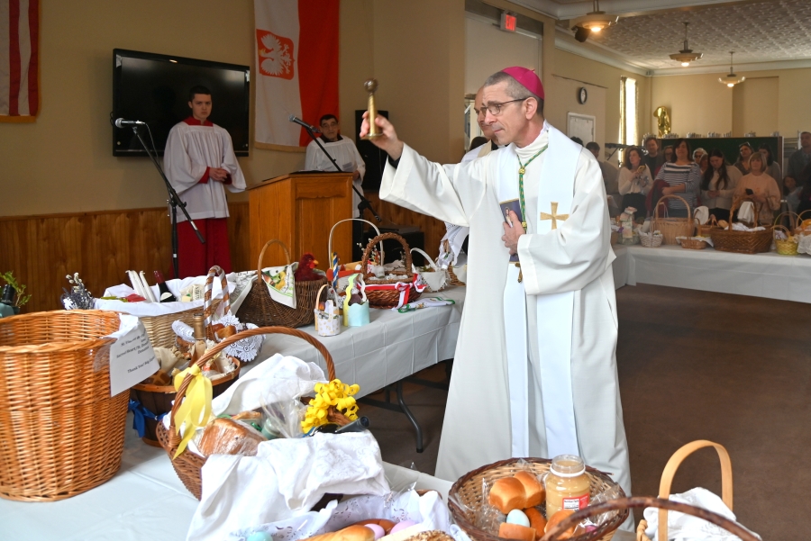 Bishop Ruggieri sprinkles the baskets with holy water.