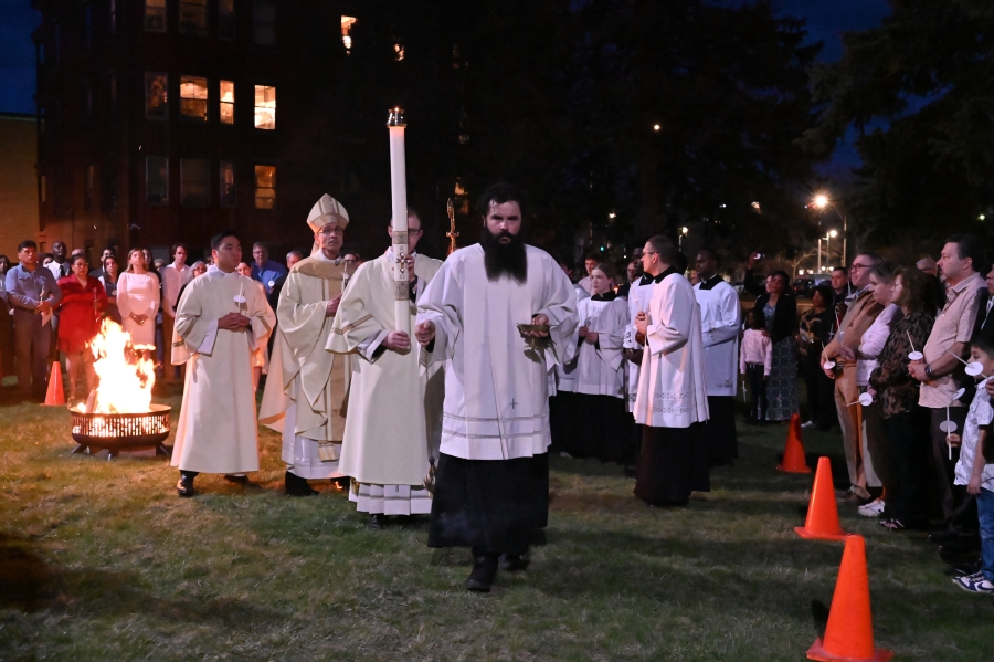 Procession led by lit candle