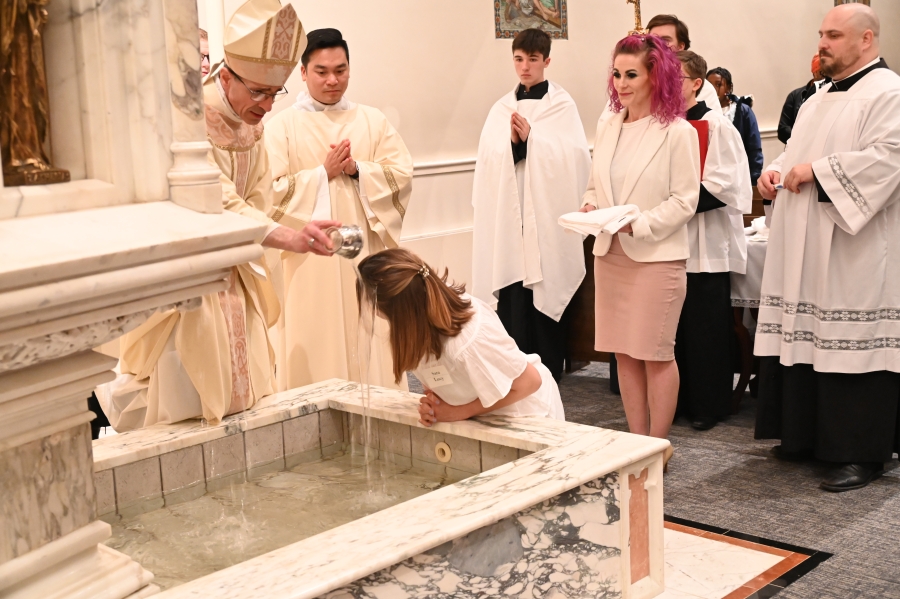 Bishop baptizes woman with water