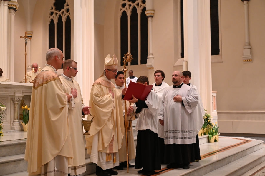 Priests gather on the altar