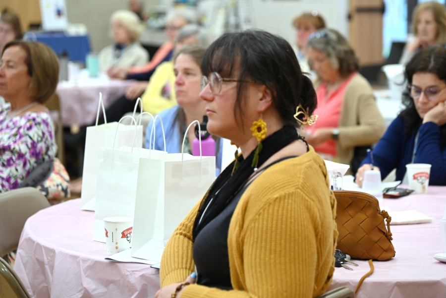 A woman listening to the speaker.