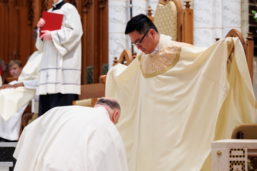 Father Daniel Greenleaf vests Father Thanh Duc Pham