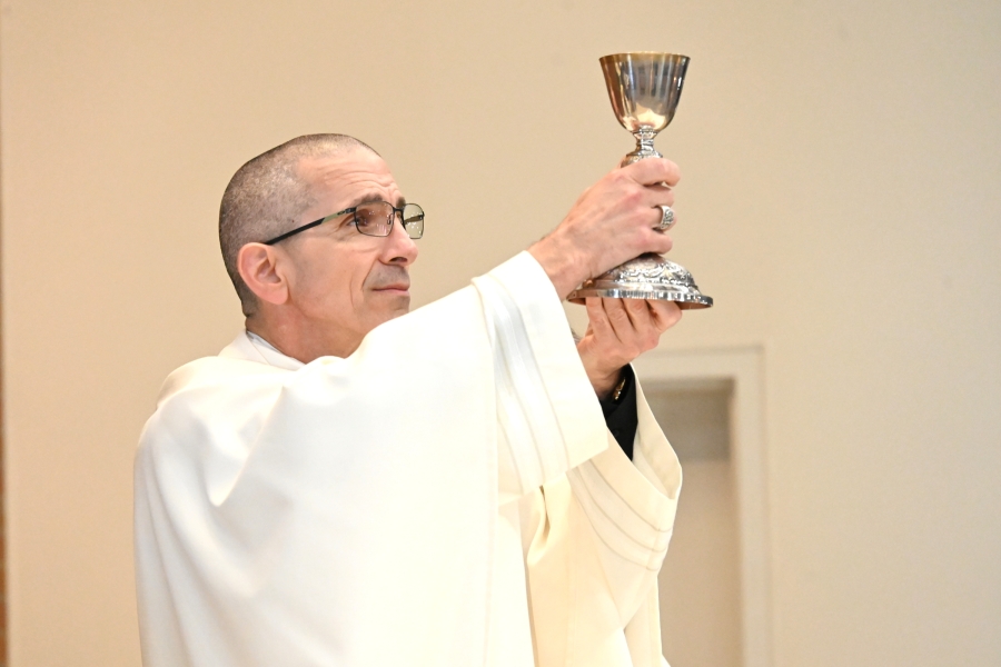 Bishop James Ruggieri holds up the chalice during consecration.