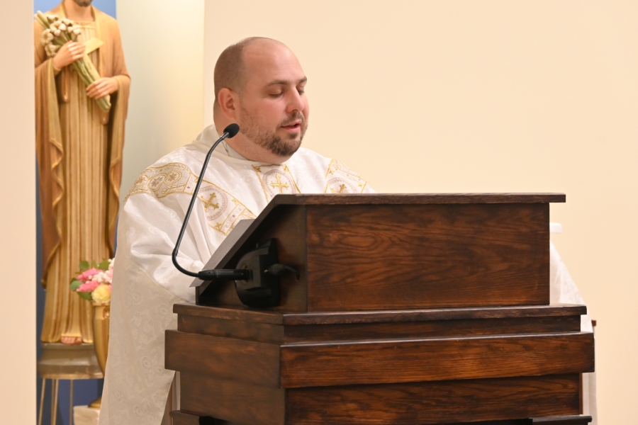 Father Brad Morin reads the Gospel.