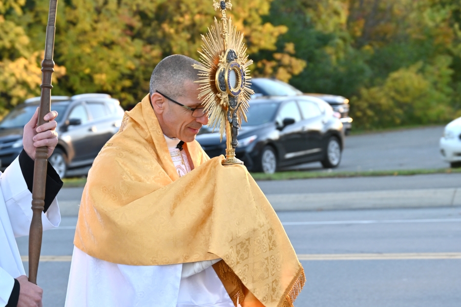 Bishop James Ruggieri carries the monstrance.