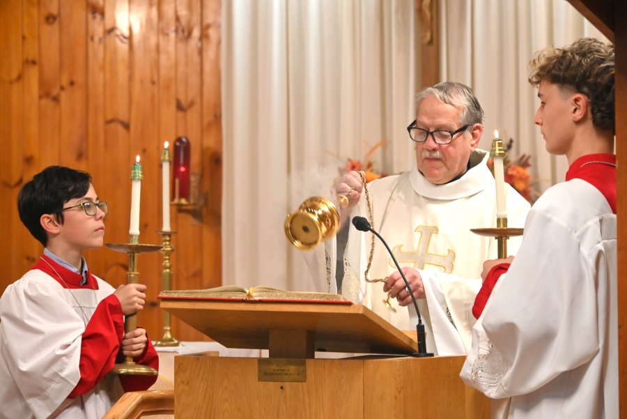 Deacon Dennis Popadak incenses the Book of the Gospels.