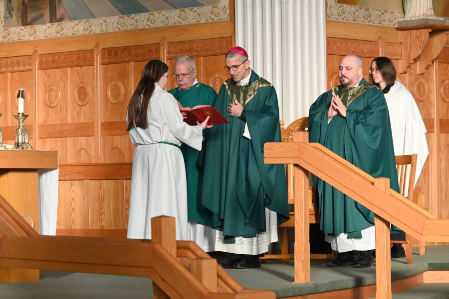 Bishop James Ruggieri delivers the opening prayer, with Father Brad Morin, Deacon Frank Daggett, and altar servers