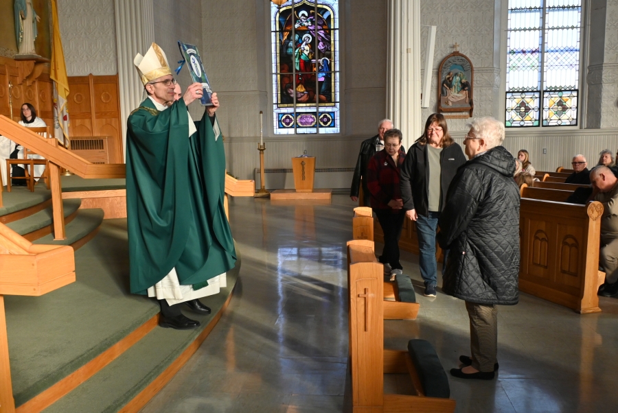 Bishop James Ruggieri holds up the Matthew 25 Award