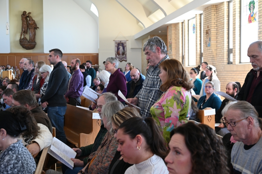 A group stands at St. John the Baptist Church in Winslow