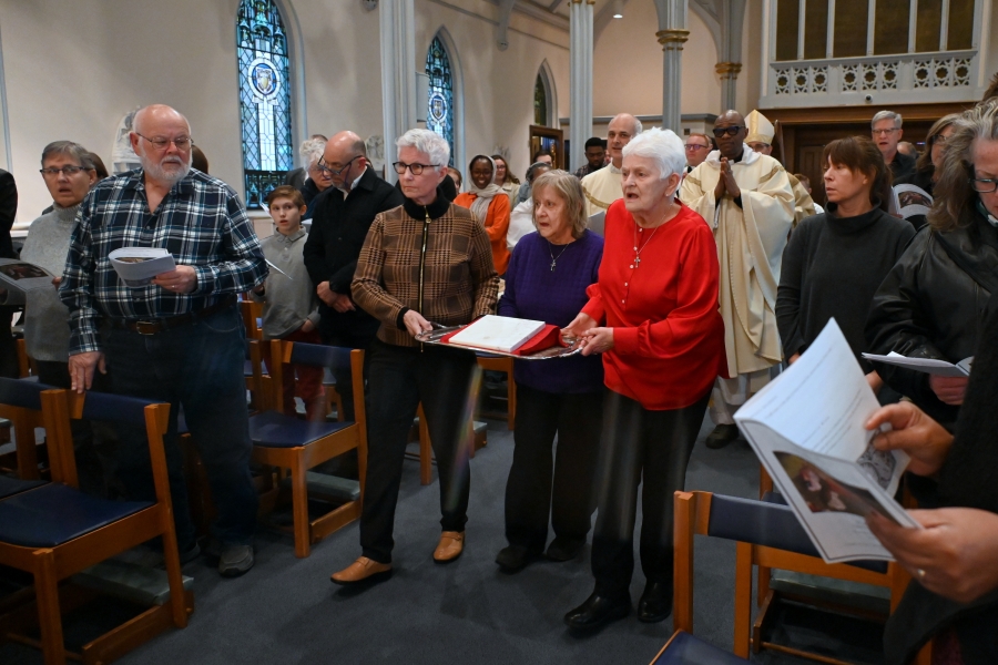 Women carry up the relic of St. Patrick.