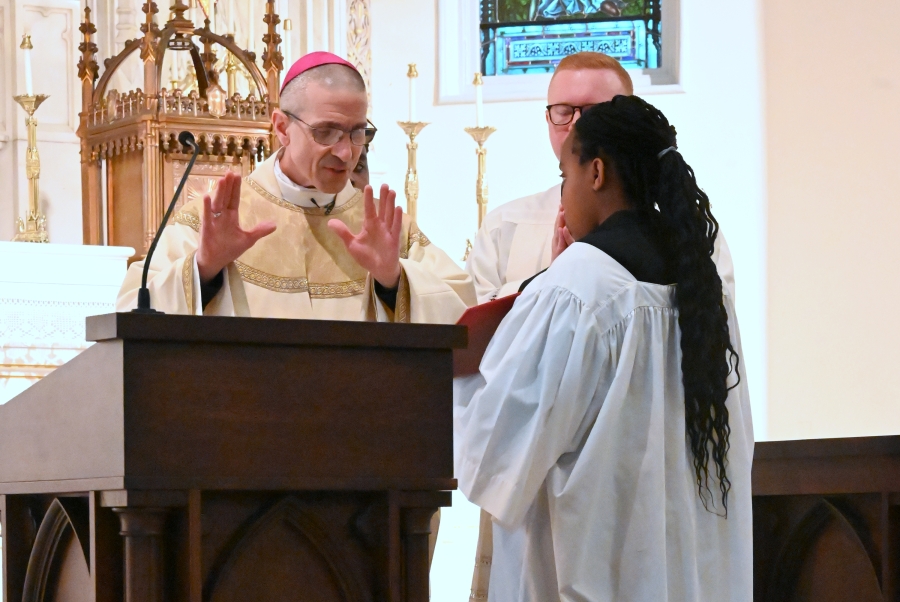 Bishop Ruggieri prays over the altar.