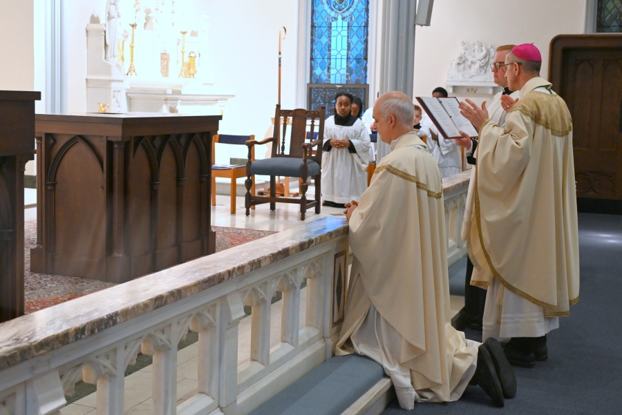 Bishop Ruggieri, Father Seamus Griesbach, and Father Alex Boucher kneel before the altar while the Litany of Saints is sung.