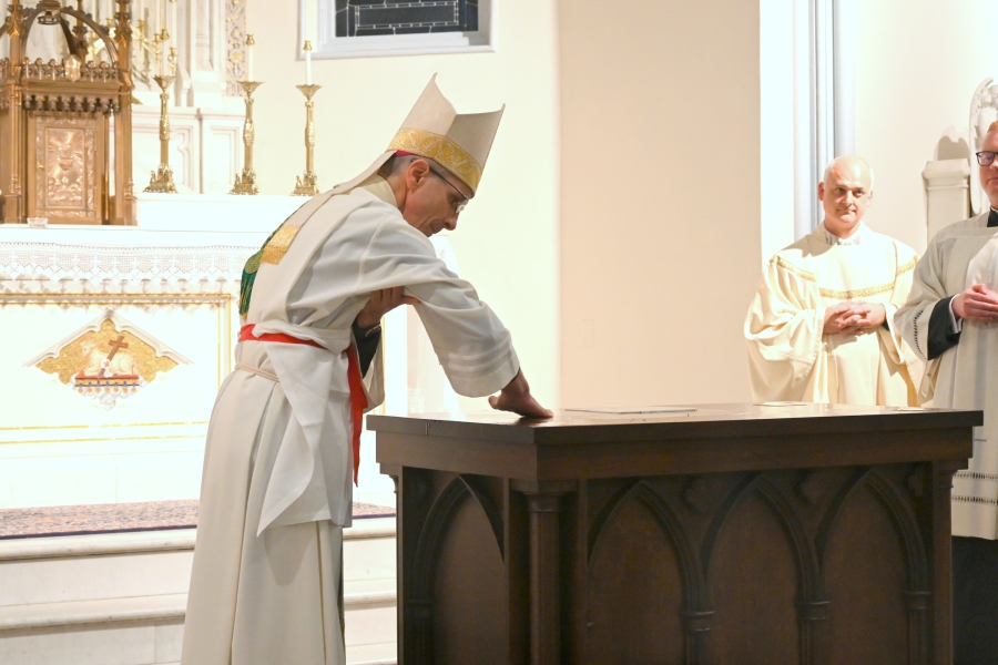 Bishop Ruggieri rubs chrism into the altar.