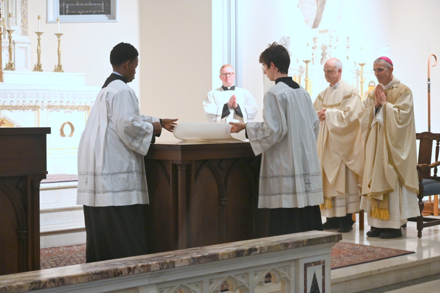 Altar serves put cloths on the altar.