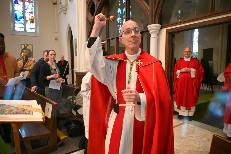 Bishop Ruggieri sprinkles palms with holy water.