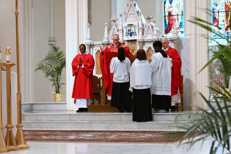 Bishop Ruggieri, Father Seamus Griesbach, Deacon Ezekiel Banla and altar servers.