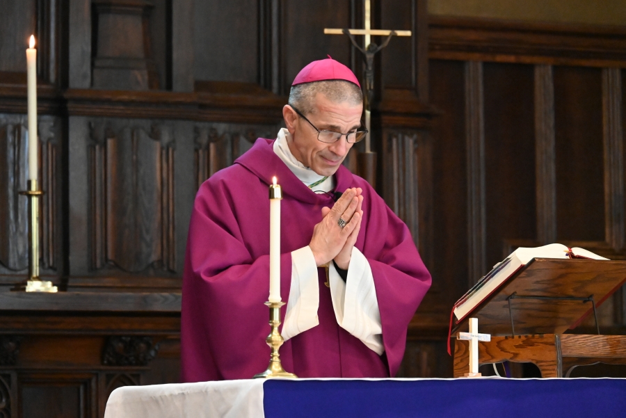 Bishop James Ruggieri praying