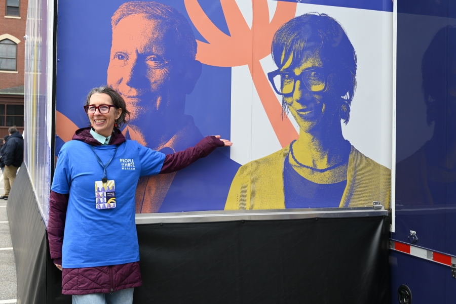 Kirsten Connelly in front of her picture on the side of the truck.