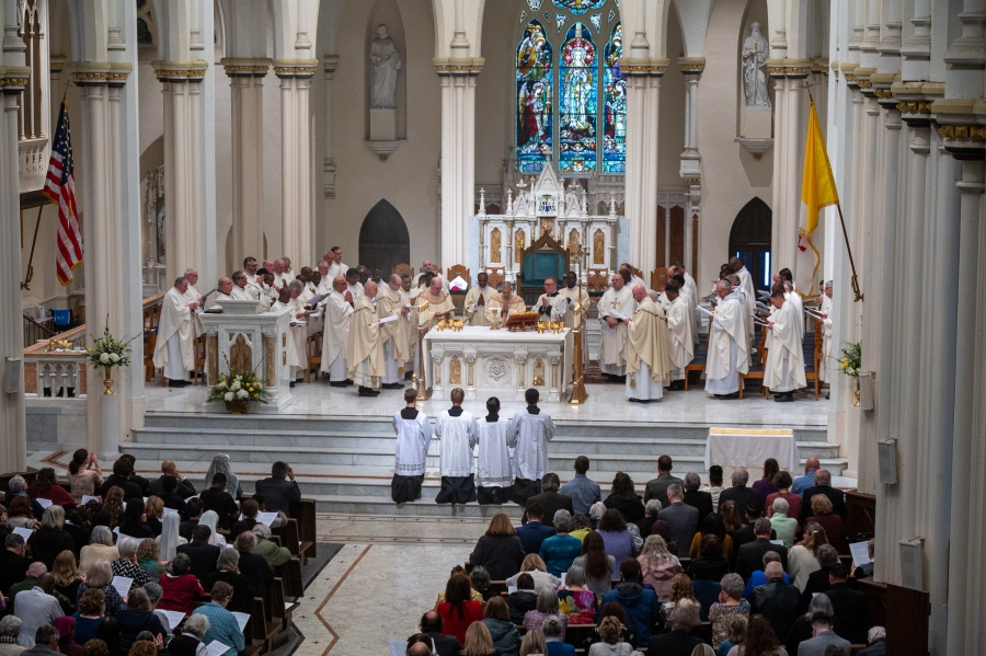 overhead view of all priests gathered in cathedral sanctuary