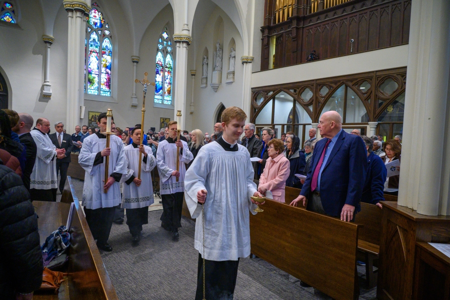 Priests exit after Mass