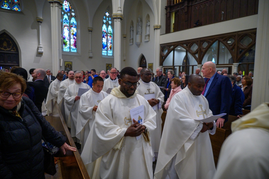 Priests exit after Mass