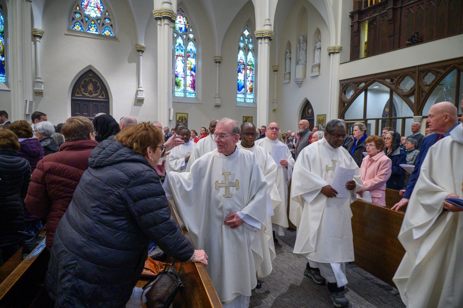 Priests exit after Mass