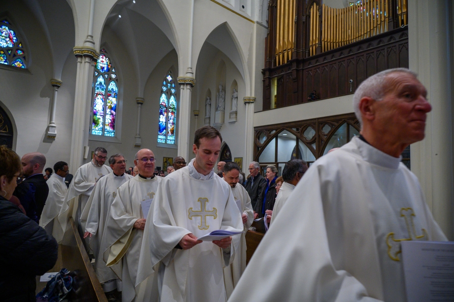 Priests exit after Mass