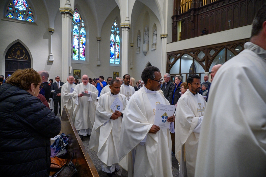 Priests exit after Mass