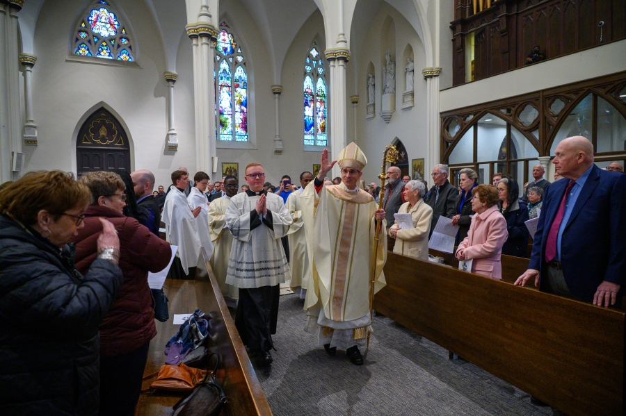 Priests exit after Mass