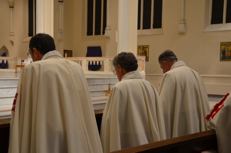 Men kneeling in the pews