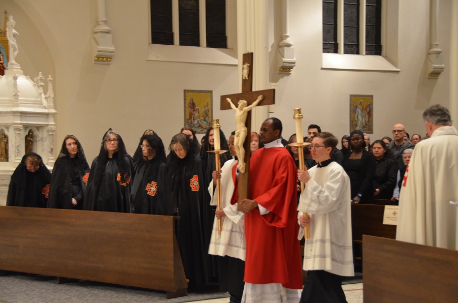 Altar servers presenting the cross