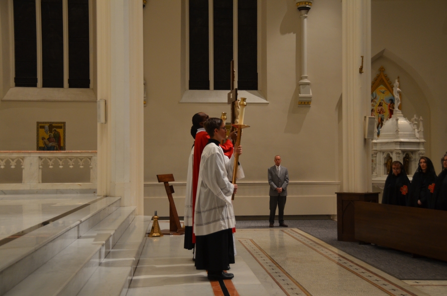 Altar servers presenting the cross.