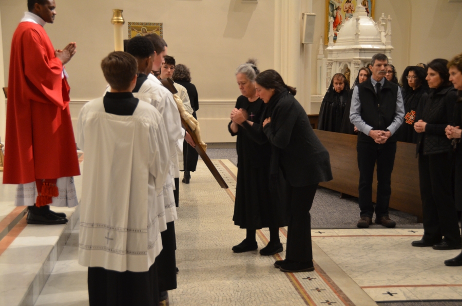 Parishioners kneeling at the cross.