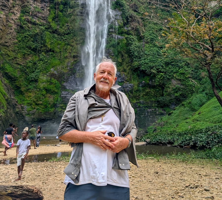 Picture of a man in front of a waterfall