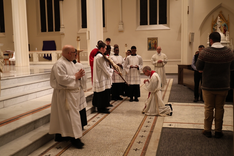 Bishop kneeling at the cross.