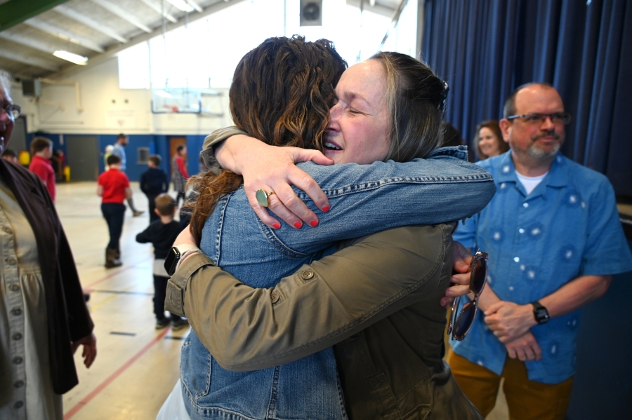 Christine Michaud receives a hug from a friend.