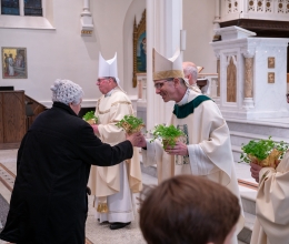 clergy handing out shamrocks after Mass