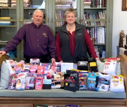 Jail ministry volunteers behind donated items.