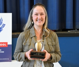 Christine Michaud holding her Teacher of the Year Award.
