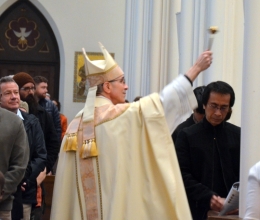 Bishop Ruggieri sprinkles the congregation with holy water.
