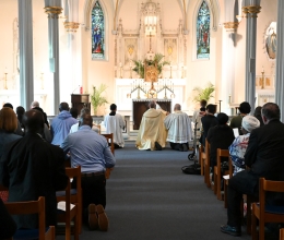 Bishop James Ruggieri incenses the altar; view from the back of the church
