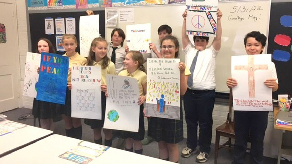 Students holding up posters